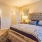 a bedroom with a bed and a mirror
