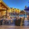a patio with tables and chairs and umbrellas and a fire pit