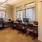 an office with a desk and chairs and computers
