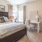 a bedroom with a bed and a chair
