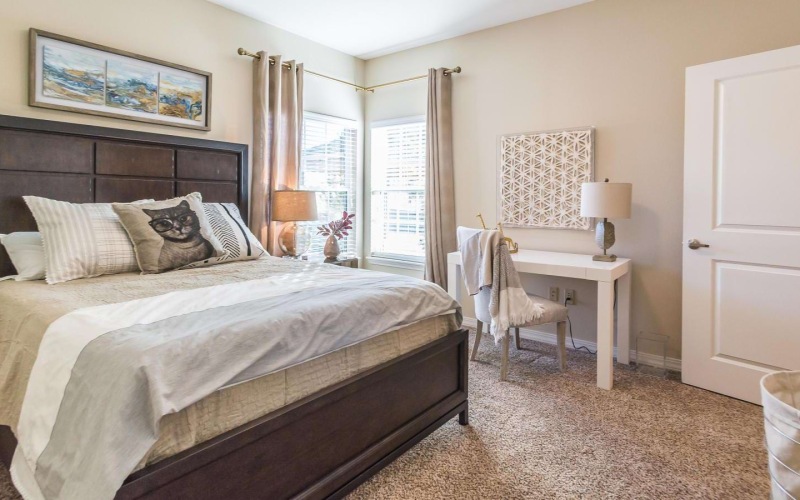 a bedroom with a bed and a chair